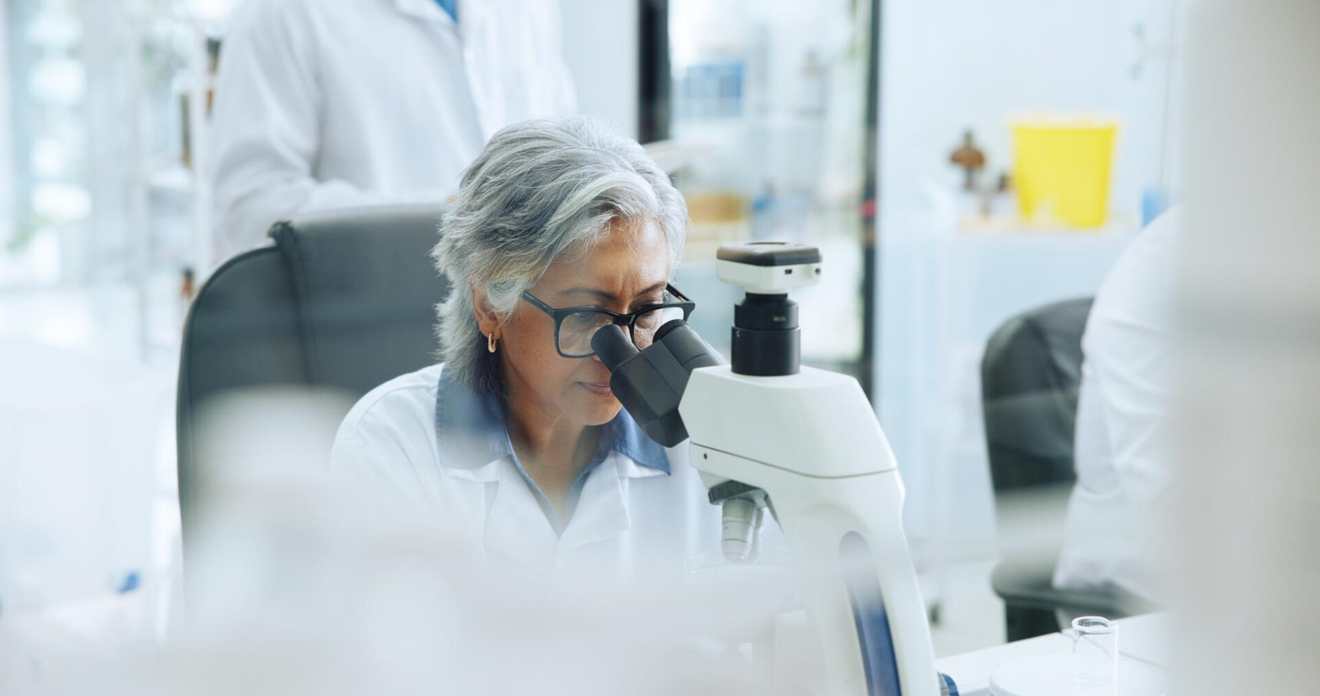 scientist looking at microscope