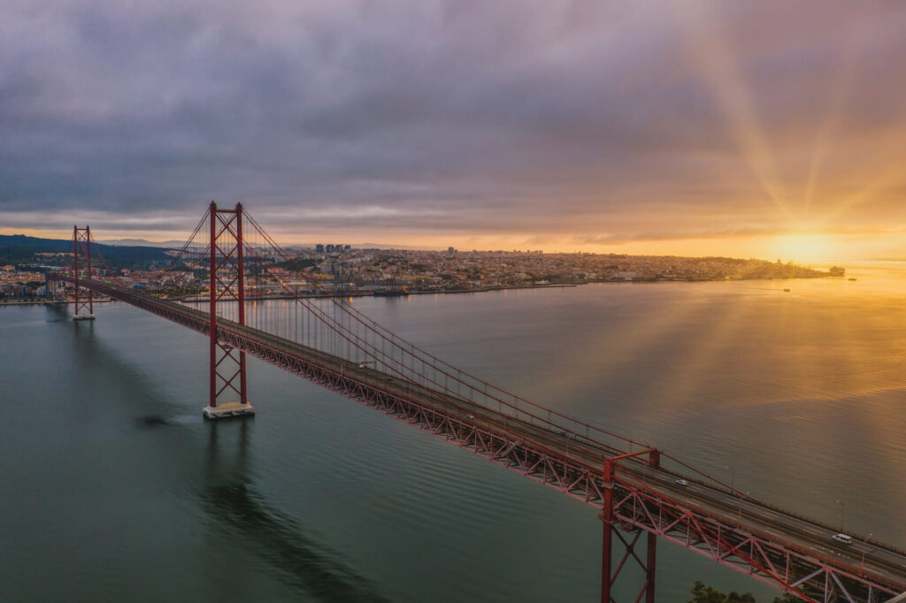 Aerial view shot suspension bridge portugal beautiful sunset (1) (1)